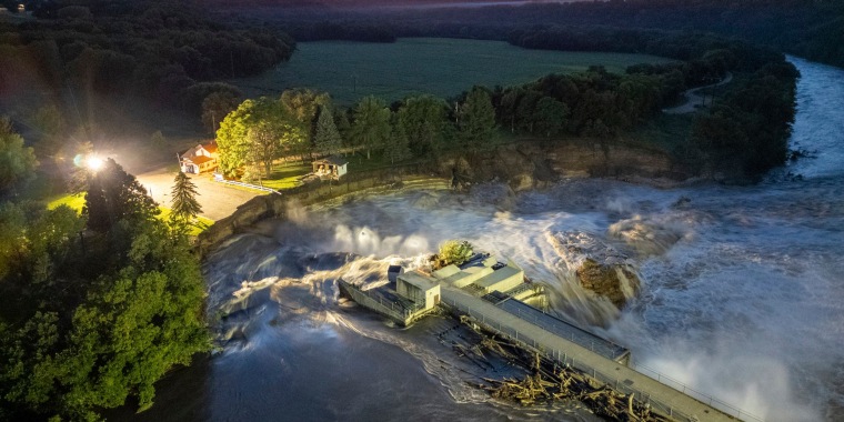 Long-exposure drone photo shows a home as it teeters before partially collapsing into the Blue Earth River at the Rapidan Dam